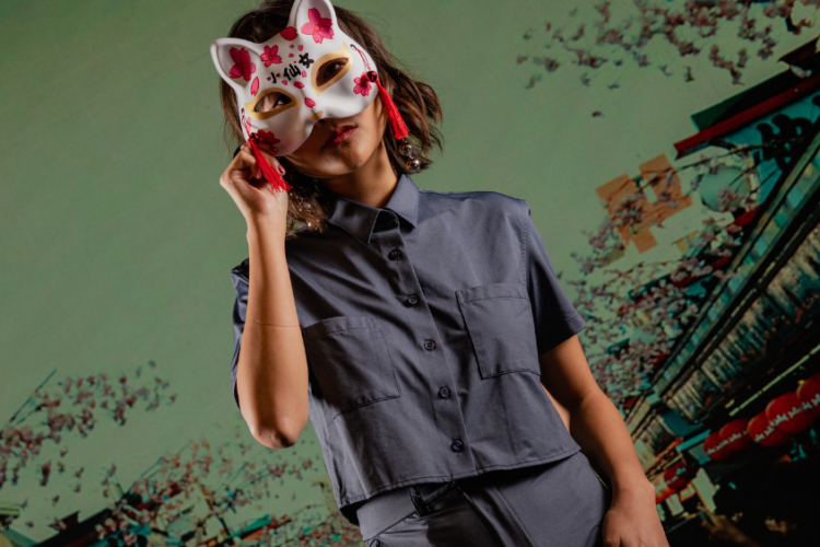 Mulher usando camisa Casual Tech® em cenário urbano com inspiração asiática, representando tecnologia têxtil aplicada ao cotidiano com conforto e mobilidade.