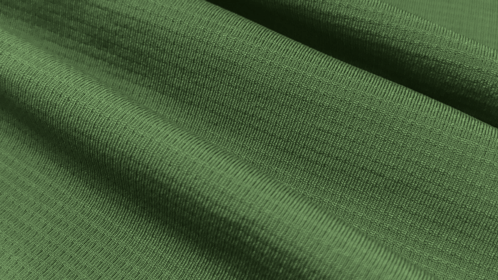 Detalhe do tecido Grafiato da Diklatex em verde, com tecnologia Dry para gerenciamento de umidade.